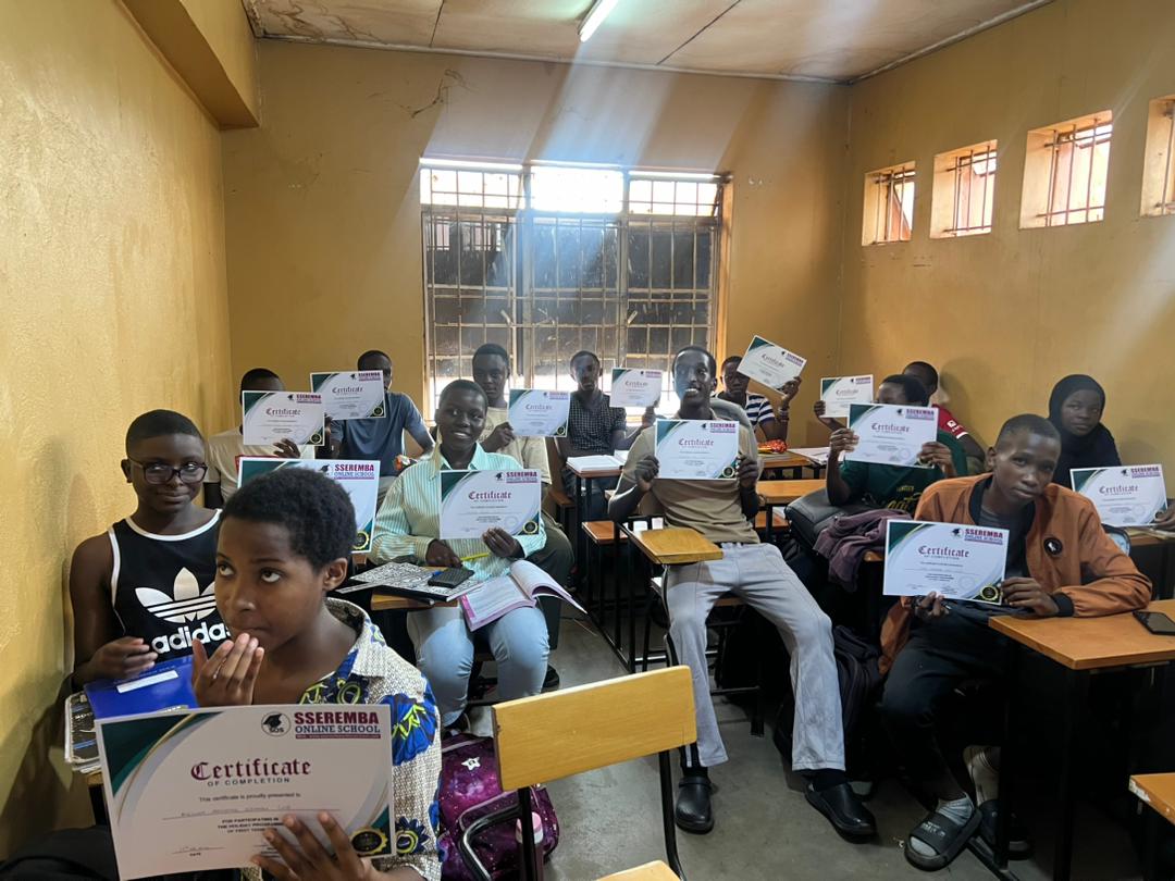 Sseremba students holding completion certificates in a classroom